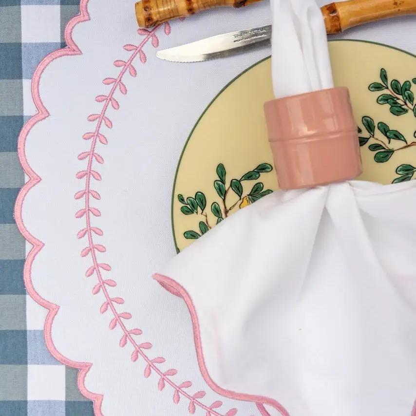 Arrow Placemat for Dining Protection by Talah Home with pink scalloped embroidery on table on Tampa Home & Garden Store