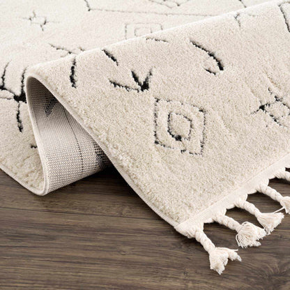 Thian Tribal Area Rug by Boutique Rugs, cream shag with black geometric motifs and tassels on Tampa Home & Garden Store