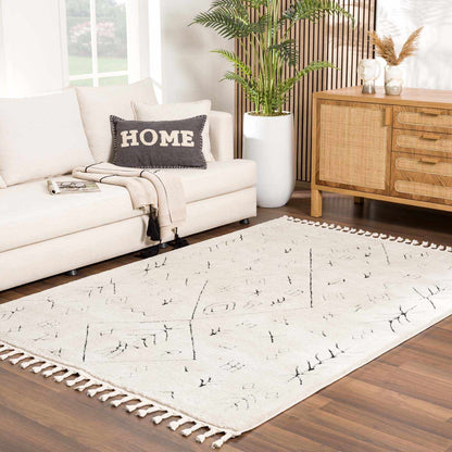 Thian Tribal Area Rug ivory with black geometric motifs and tassel fringe in living room on Tampa Home & Garden Store