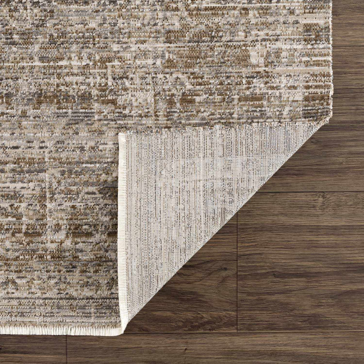 Uzuri Washable Outdoor Area Rug in tan and cream with distressed pattern on wood floor on Tampa Home & Garden Store