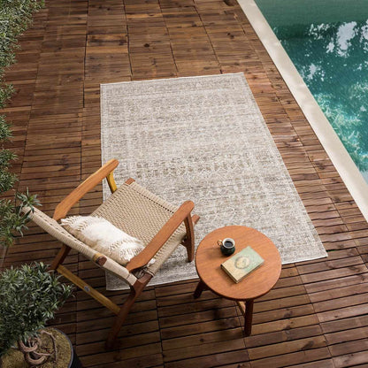 Uzuri Washable Outdoor Area Rug by Boutique Rugs in neutral gray beige pattern on wooden pool deck on Tampa Home & Garden Store