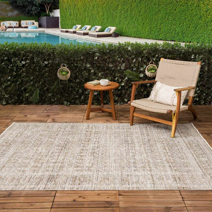 Uzuri Washable Outdoor Area Rug by Boutique Rugs, beige woven outdoor rug on wooden deck on Tampa Home & Garden Store