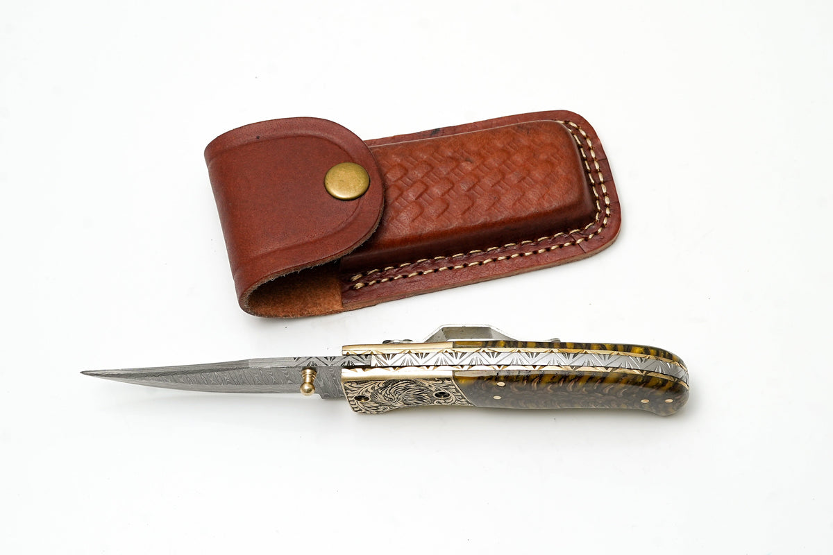 Damascus clip-point knife TF-104 by Titan Int'l K with eagle bolster and amber pine cone handle on Tampa Home & Garden Store