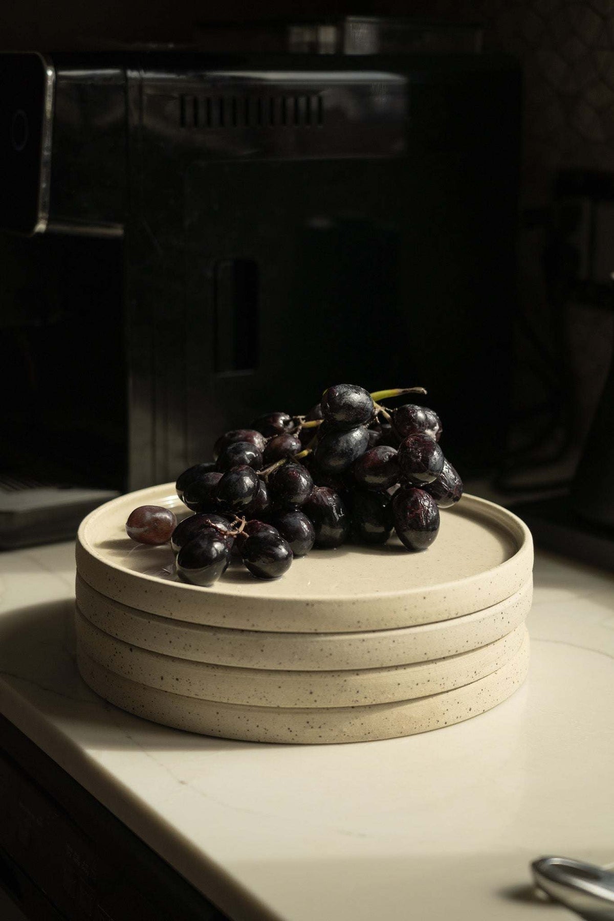 Handmade stoneware plate white with speckles, grapes atop stack by CREATING COMFORT on Tampa Home & Garden Store