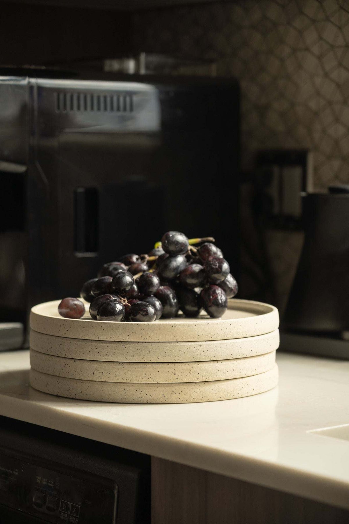 Handmade stoneware plates stack of four speckled white plates with grapes on top on Tampa Home & Garden Store