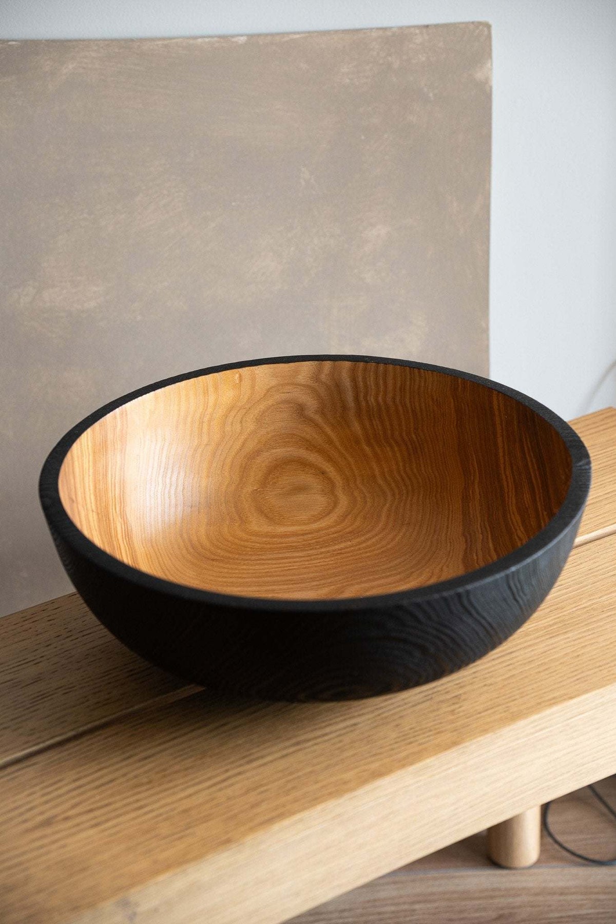 Hand carved extra large wooden fruit bowl with half-charred exterior and warm grain interior on Tampa Home & Garden Store