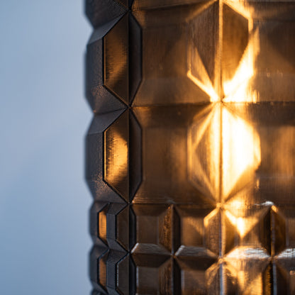 Gem Sconce wall light by Wooj Design with bronze copper geometric metal facets warm amber glow on Tampa Home & Garden Store