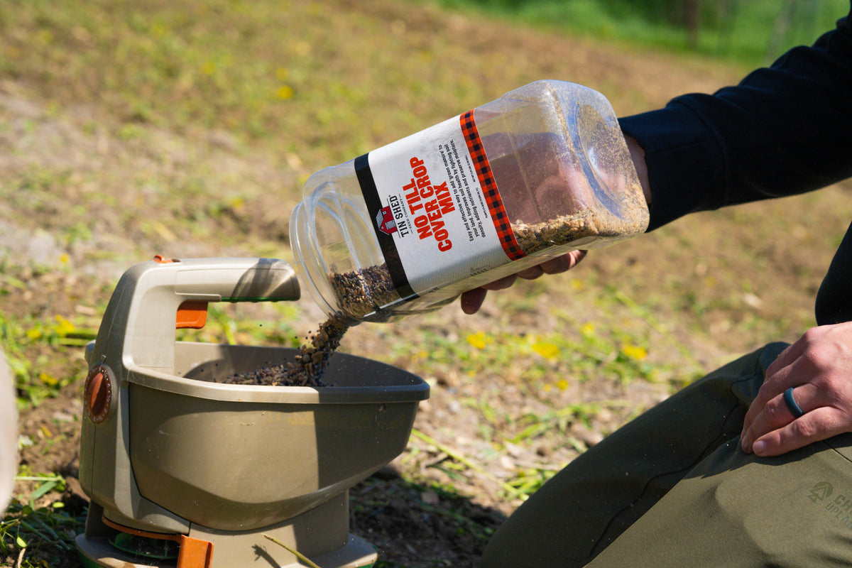 No Till Cover Crop Mix seeds from Tin Shed Seed Company poured into a seed spreader on Tampa Home & Garden Store