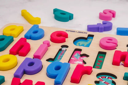 Find & Fit Puzzle letters by Domino & Juliette, colorful plastic alphabet on a wooden board with cutouts and a dinosaur image on Tampa Home & Garden Store