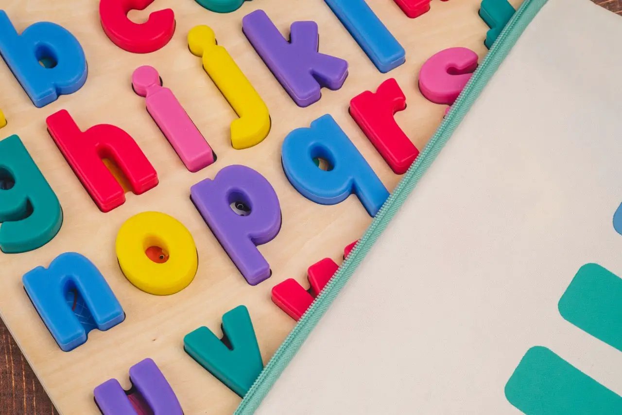 xyz Find & Fit Puzzle colorful plastic letter tiles on a wooden board by Domino & Juliette on Tampa Home & Garden Store