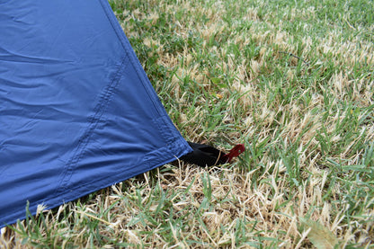Hammock Rain Fly by River Country Gear in blue nylon with ground strap and red stake visible on Tampa Home & Garden Store