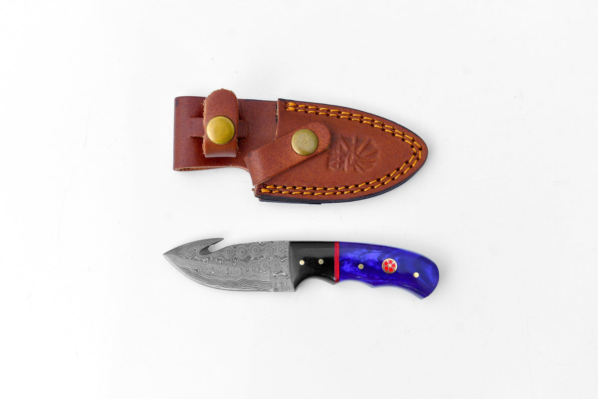 Titan Midnight Talon TK-222 knife with Damascus blade and blue handle beside brown leather sheath on Tampa Home & Garden Store