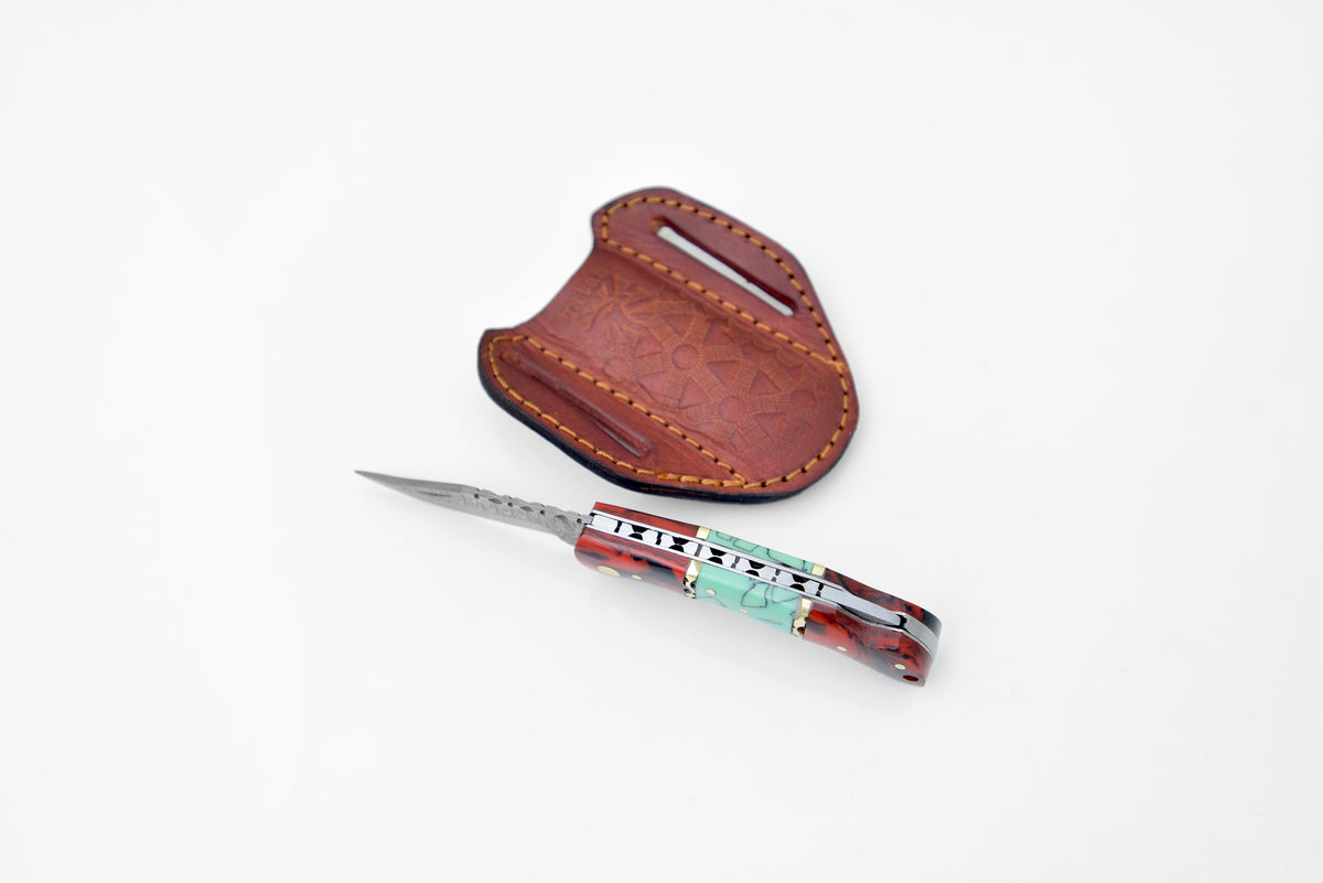 Damascus steel pocket knife TF-050 by Titan K with red-blue resin handle and leather sheath on Tampa Home & Garden Store