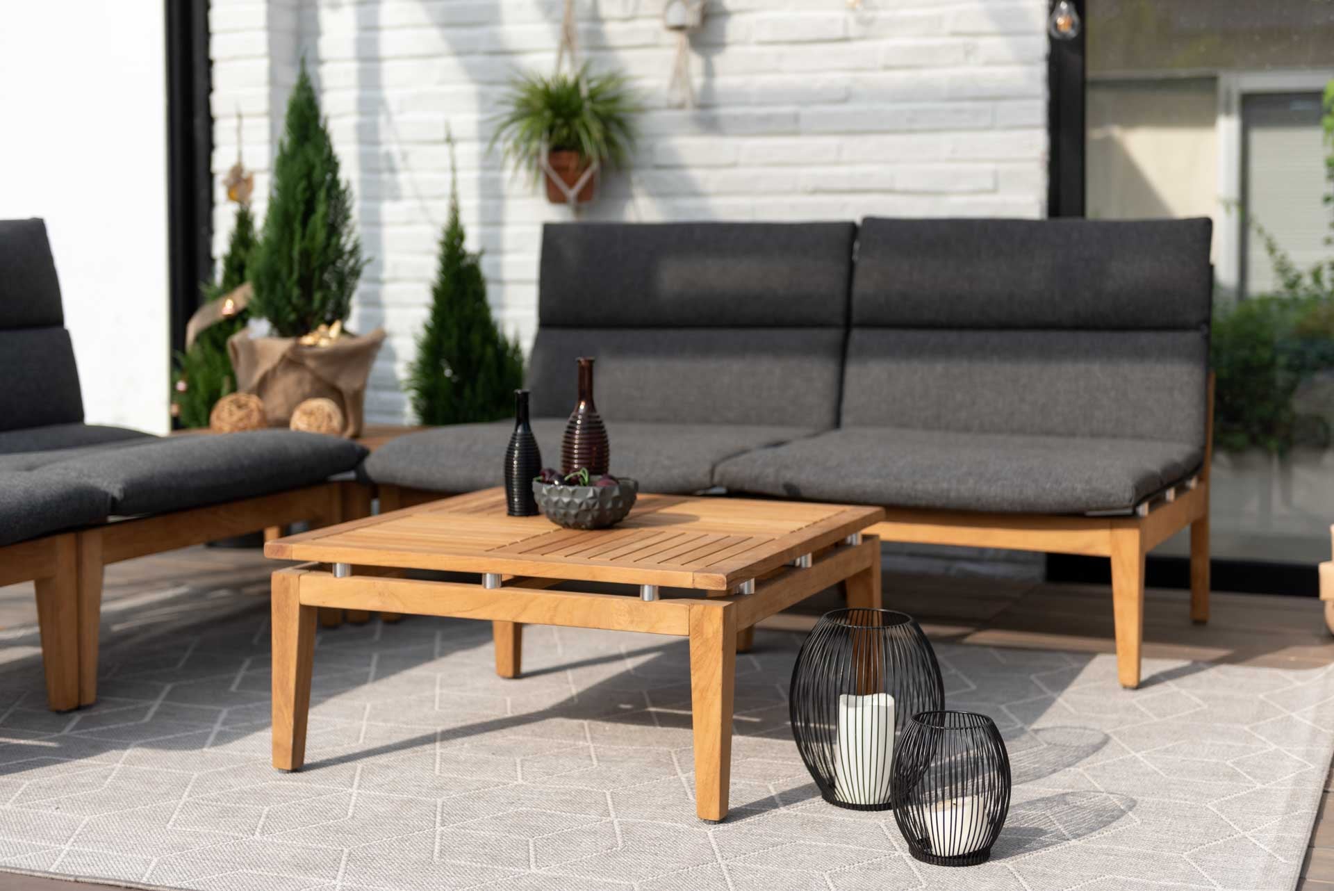 Arno 6pc Corner Set Dark outdoor sectional with natural wood frame and dark cushions on a patio on Tampa Home & Garden Store