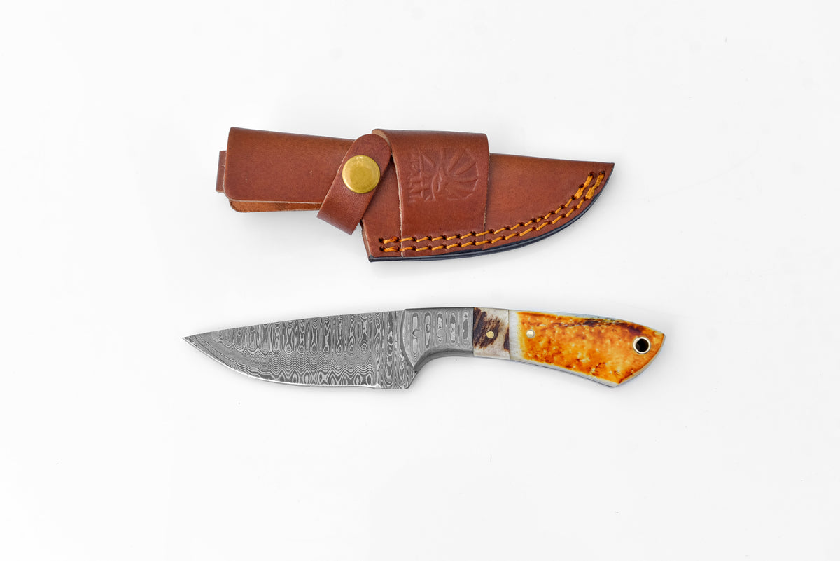 Titan Scorched Timber Damascus EDC Knife with orange handle in leather sheath on Tampa Home & Garden Store