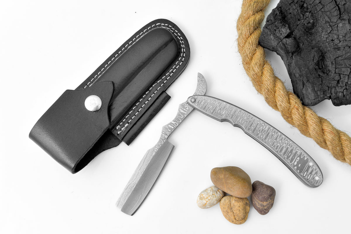 TD-041 Titan knife with Damascus-pattern blade in black leather sheath, rope and stones on Tampa Home & Garden Store