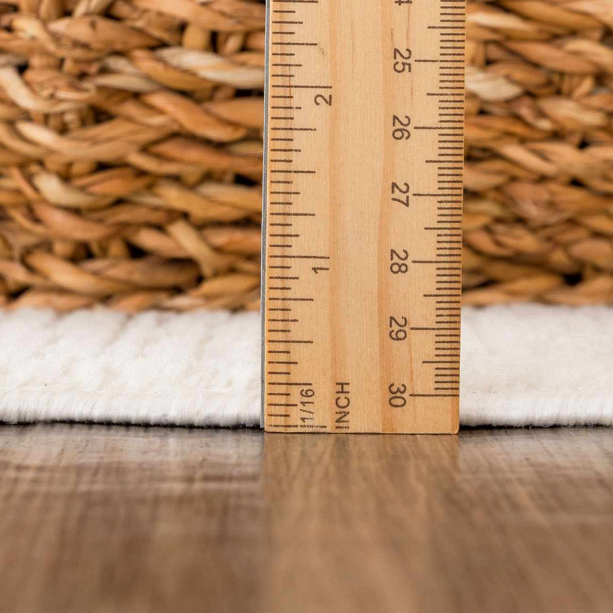 Leanna Cream Washable Area Rug Boutique Rugs; cream soft rug beside a wooden ruler for scale on Tampa Home & Garden Store