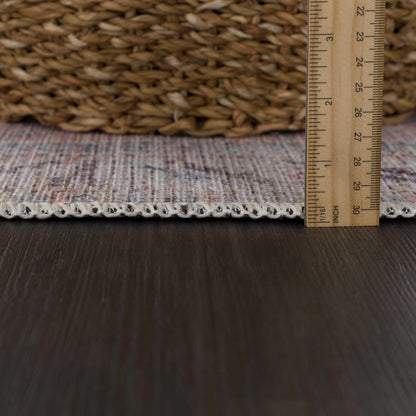 Morcott Peach washable area rug with peach woven pile and beige border for scale on Tampa Home & Garden Store