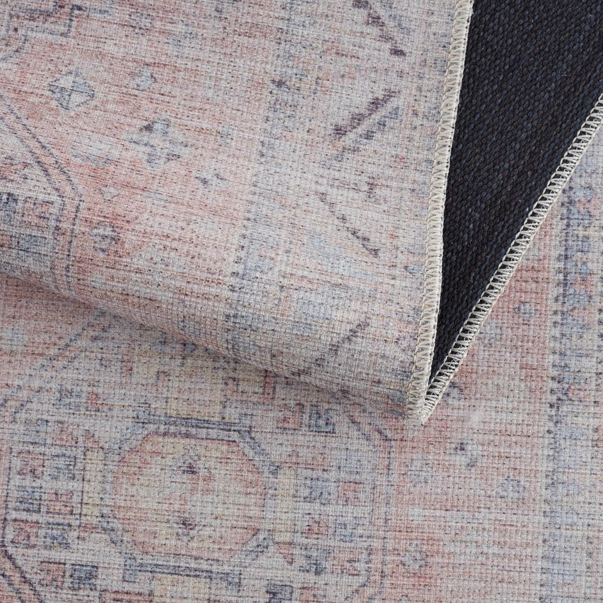 Morcott Peach Washable Area Rug with distressed pattern and beige edge stitching on Tampa Home & Garden Store