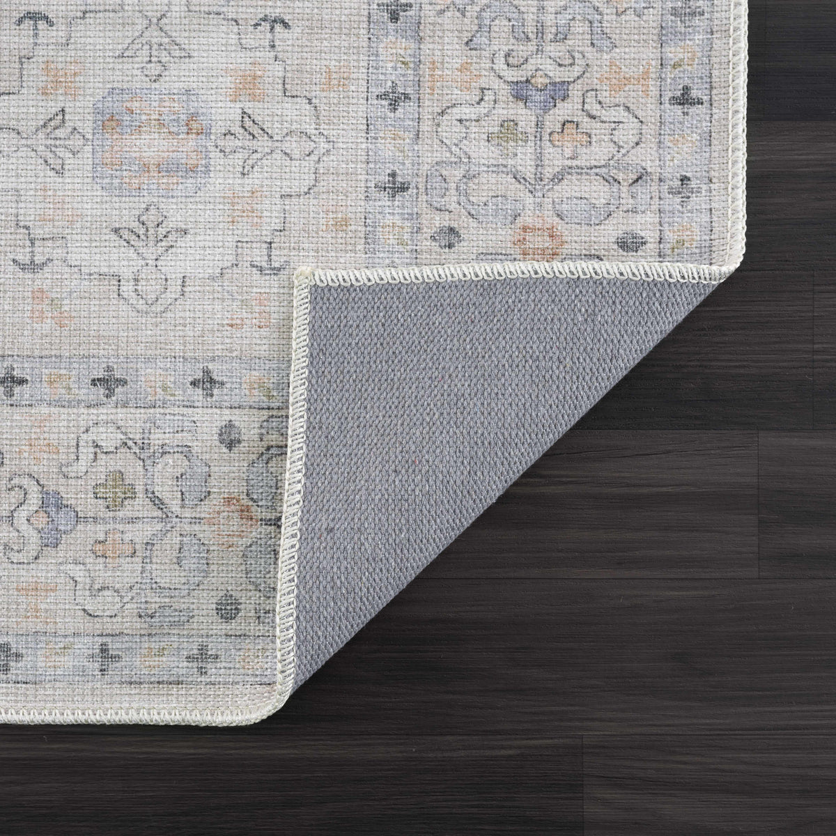 Beige Beckett washable rug by Boutique Rugs with muted gray traditional pattern and fringe edge on Tampa Home & Garden Store