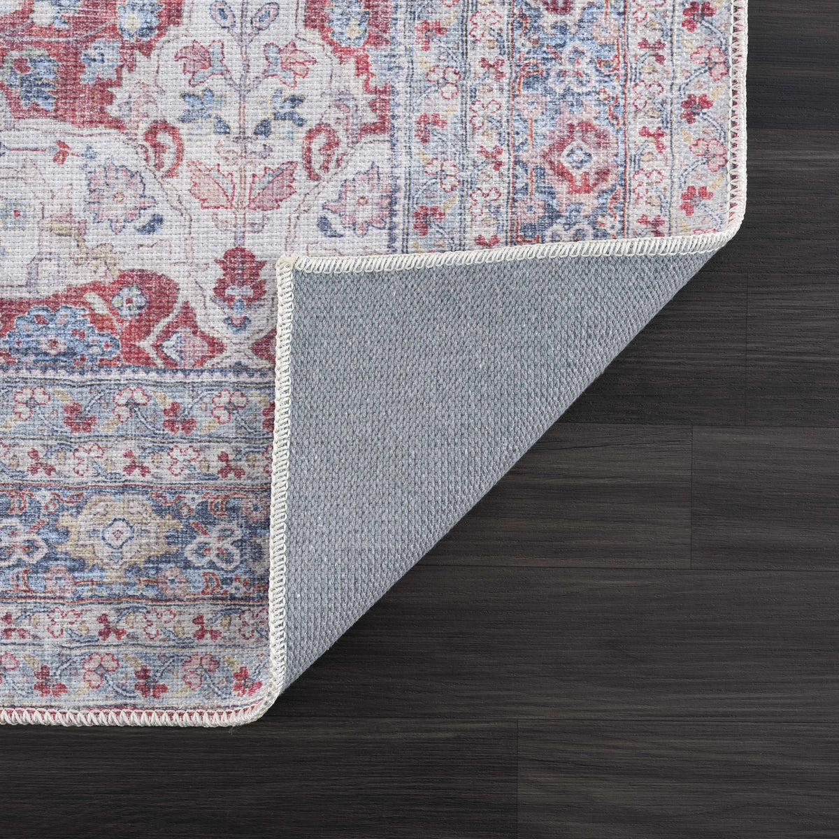 Rust Goma Vintage Area Rug red blue antique floral design Boutique Rugs on dark wood floor on Tampa Home & Garden Store