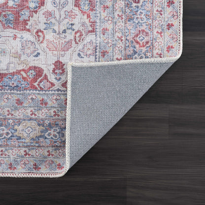 Rust Goma Vintage Area Rug red blue antique floral design Boutique Rugs on dark wood floor on Tampa Home & Garden Store