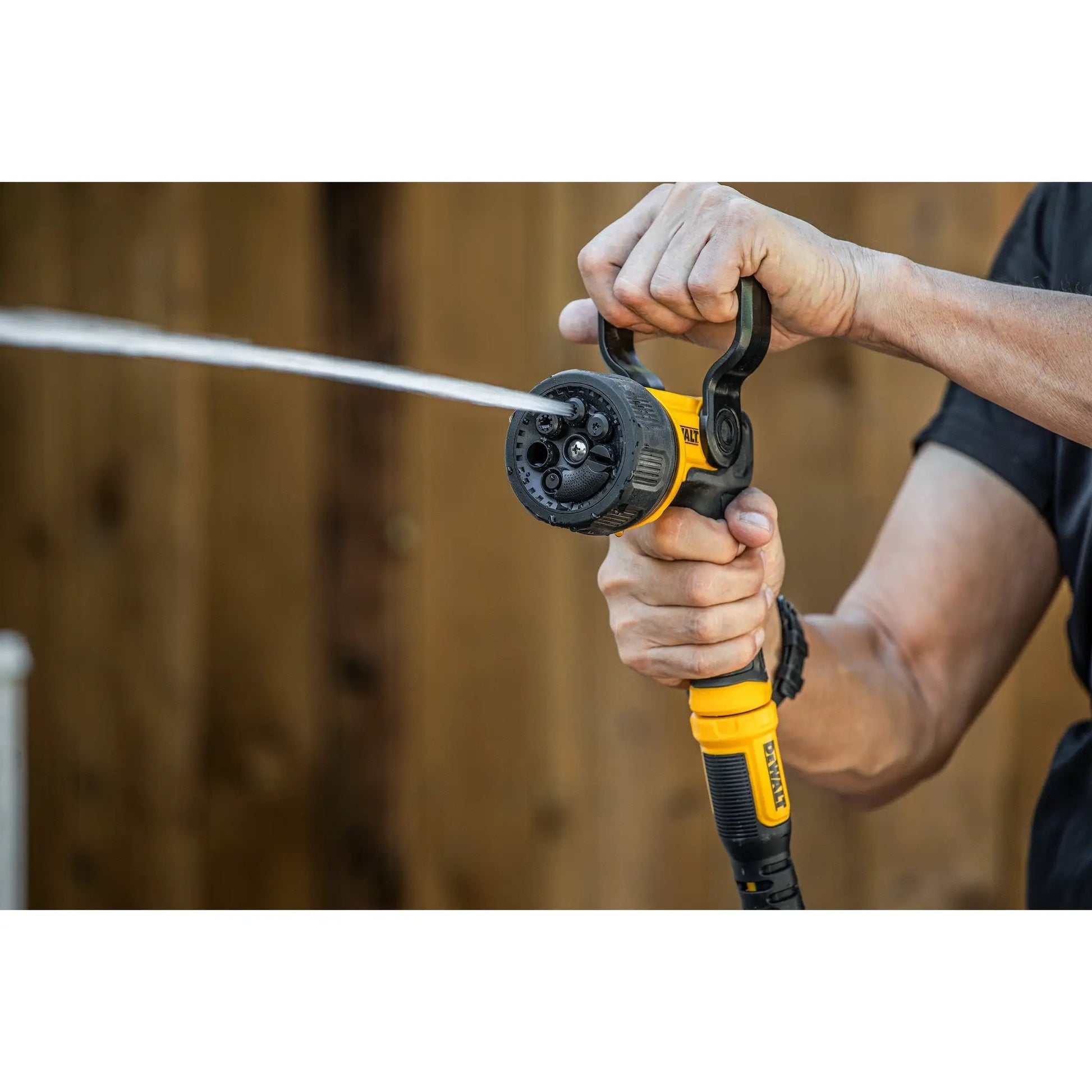 DEWALT spray nozzle with adjustable multi-pattern dial, yellow and black, hand gripping on Tampa Home & Garden Store