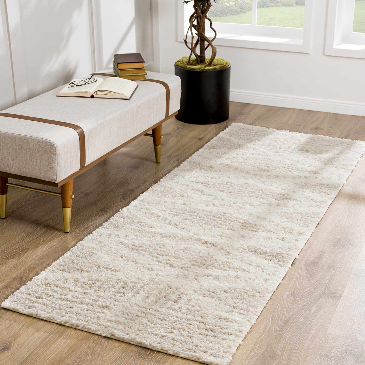 Hauteloom Trunding Plush Rug light beige on wood floor near bench with books Boutique Rugs on Tampa Home & Garden Store