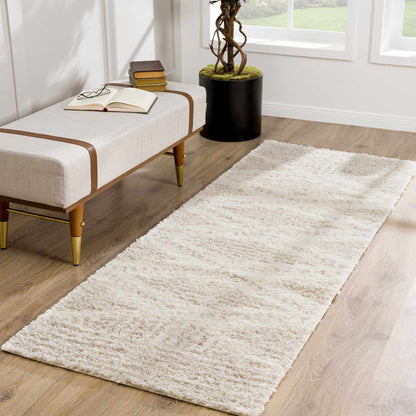 Hauteloom Trunding Plush Rug light beige on wood floor near bench with books Boutique Rugs on Tampa Home & Garden Store