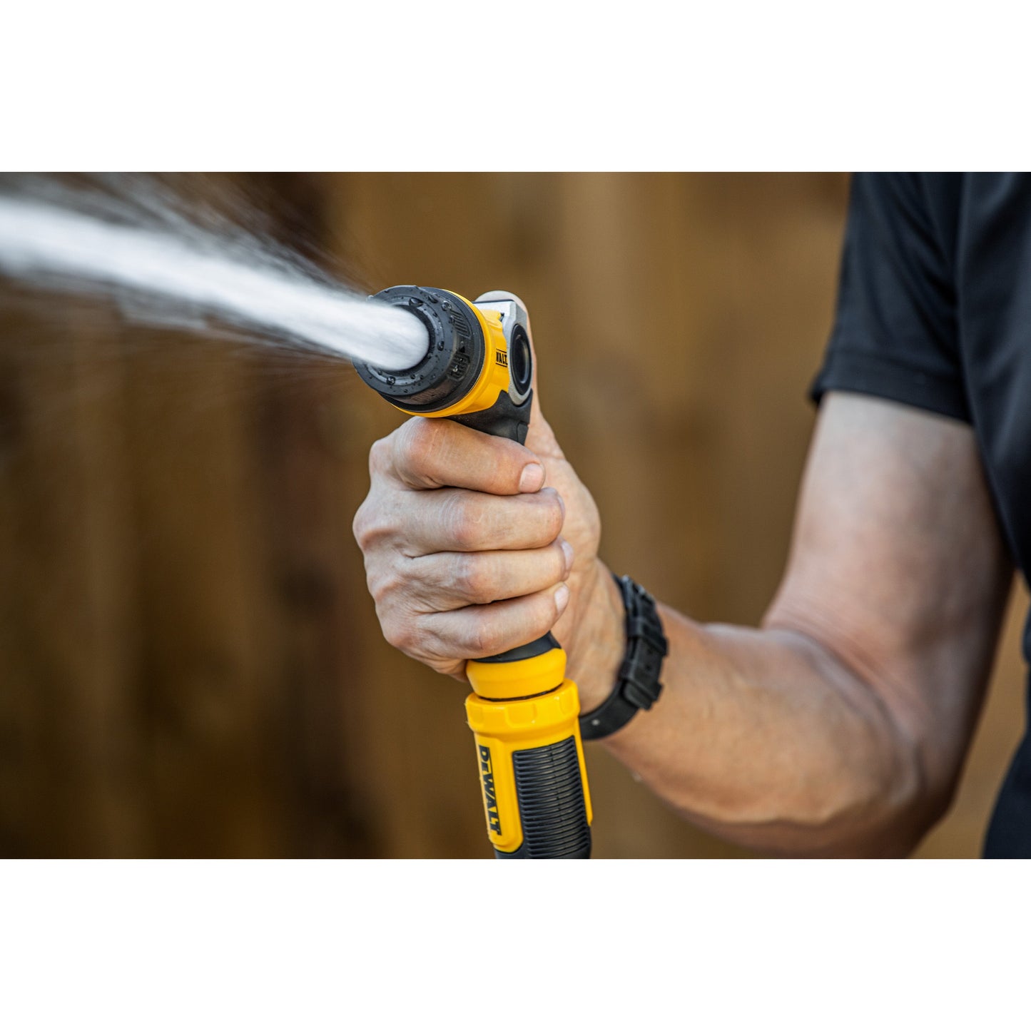 DEWALT Pattern Pro thumb-control adjustable hose end nozzle yellow and black grip in hand on Tampa Home & Garden Store