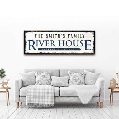 Family River House Arrow Sign canvas; bold blue RIVER HOUSE text on rustic white backdrop on Tampa Home & Garden Store