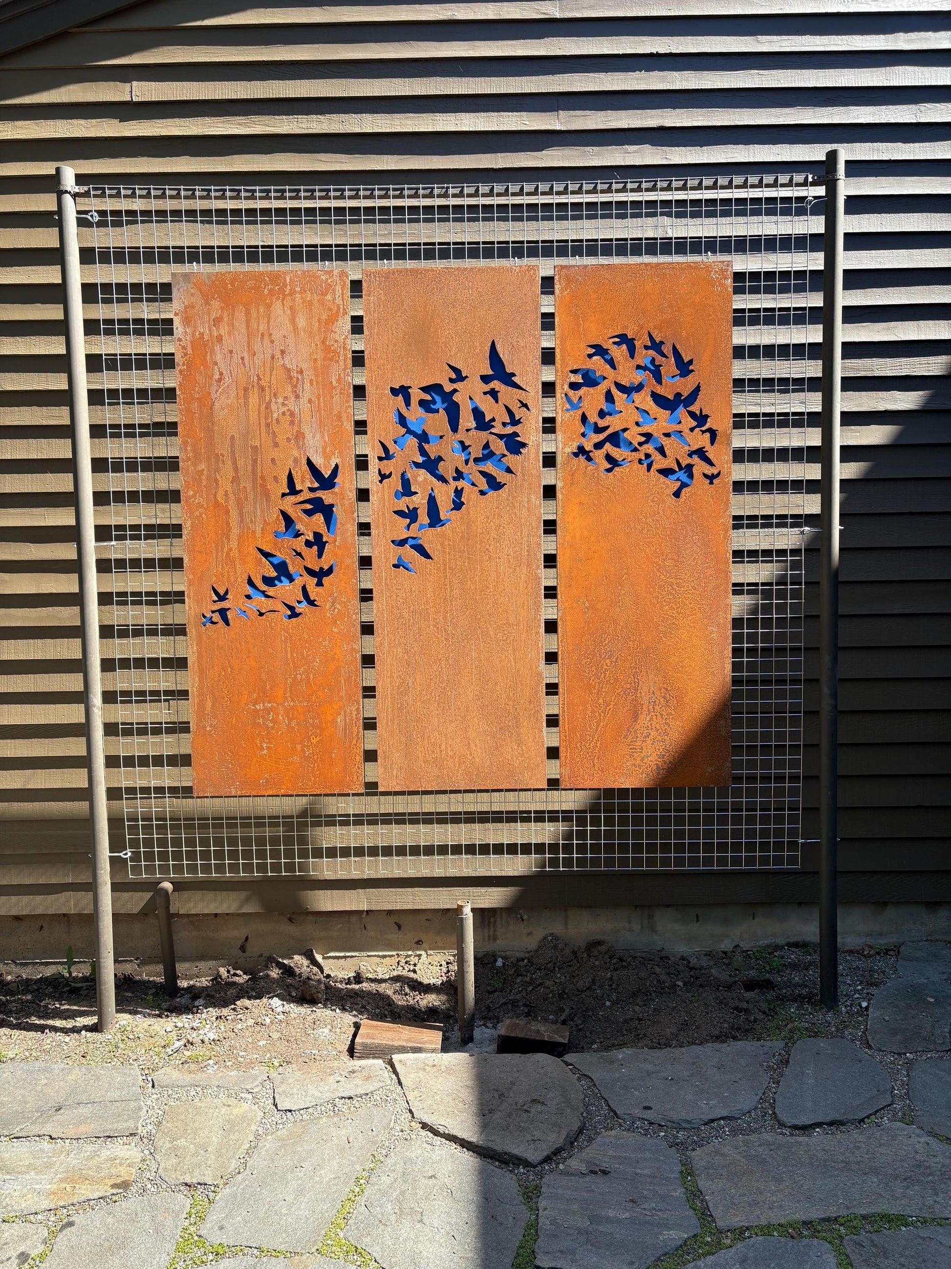 Outdoor metal wall art panels with a rusty finish and blue bird silhouettes, set of 3 panels on Tampa Home & Garden Store