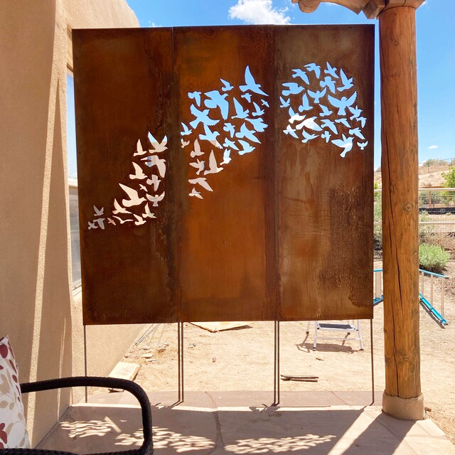 Outdoor metal privacy fence panels rusted steel with bird silhouette cutouts for backyard on Tampa Home & Garden Store