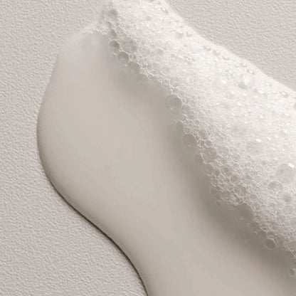 Shampoo Davines OI from Nava Beauty with white foam on a smooth surface on Tampa Home & Garden Store