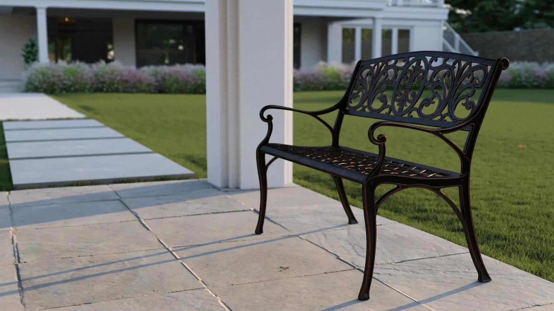 Decatur aluminum patio bench in antique bronze with ornate back and curved arms on a patio on Tampa Home & Garden Store