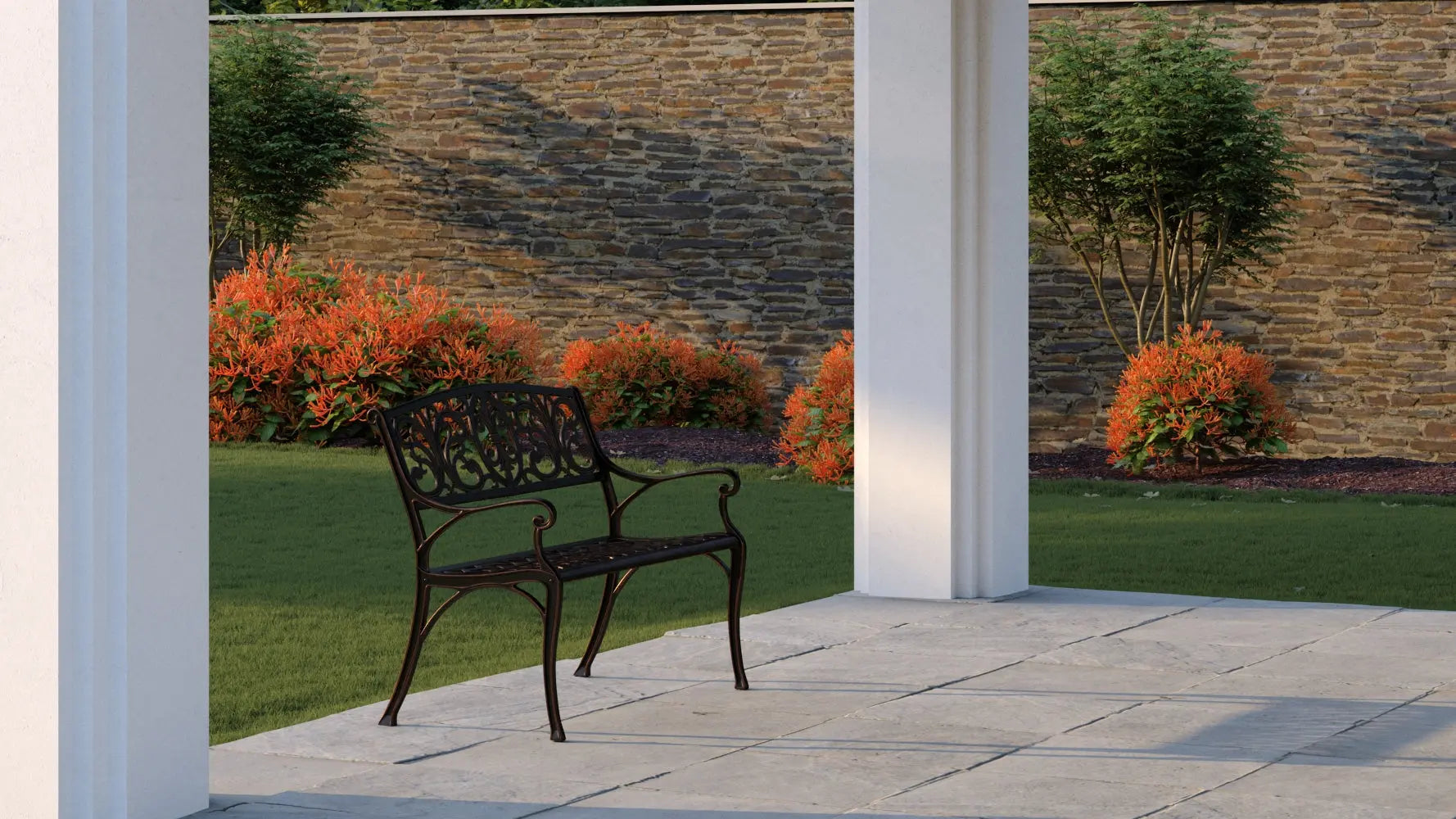 Decatur Aluminum Patio Bench antique bronze with ornate backrest on a stone patio on Tampa Home & Garden Store