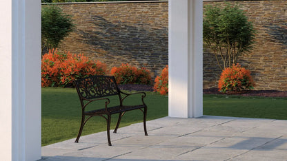 Decatur Aluminum Patio Bench antique bronze with ornate backrest on a stone patio on Tampa Home & Garden Store