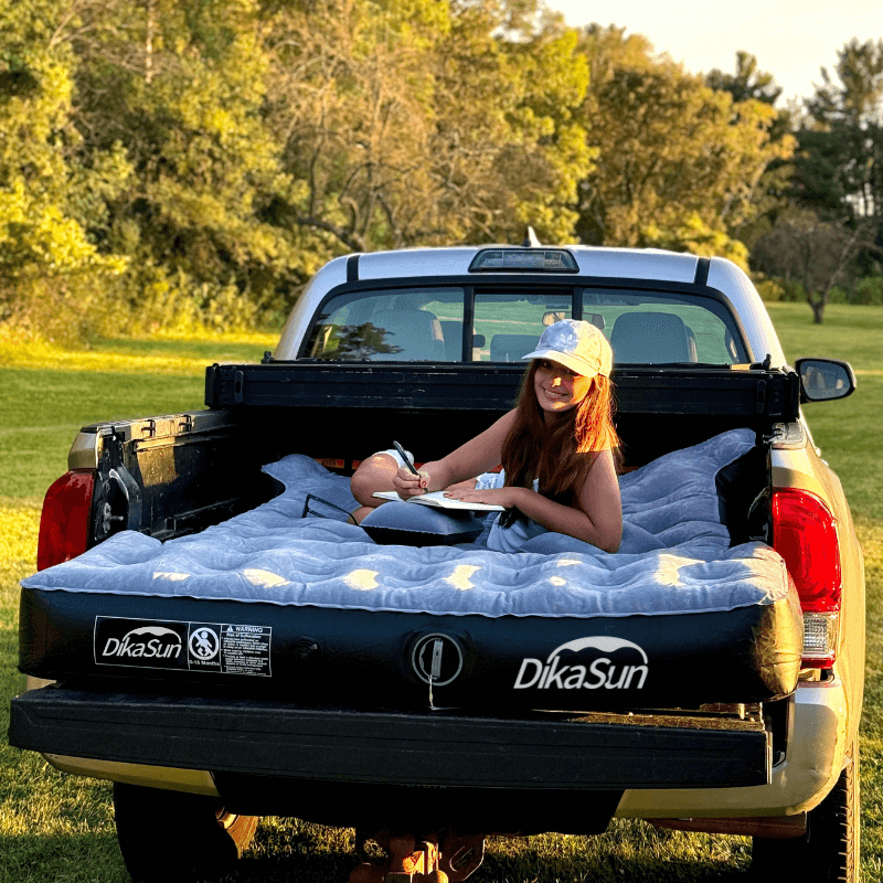 DikaSun 5.5-5.8ft auto inflate truck bed air mattress in pickup bed with a woman lounging on it on Tampa Home & Garden Store