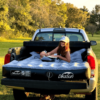 DikaSun 5.5-5.8ft auto inflate truck bed air mattress in pickup bed with a woman lounging on it on Tampa Home & Garden Store