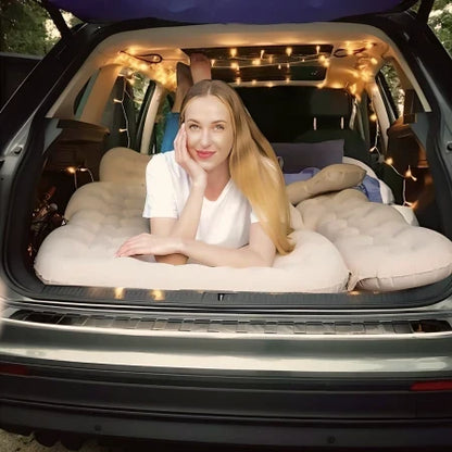 Dikasun Outdoor backseat air mattress for SUV, grey 30.31'' wide, person lounging inside SUV with string lights on Tampa Home & Garden Store