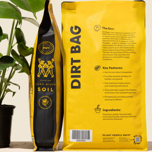 Yellow 'Dirt Bag' soil package with plant on a light background