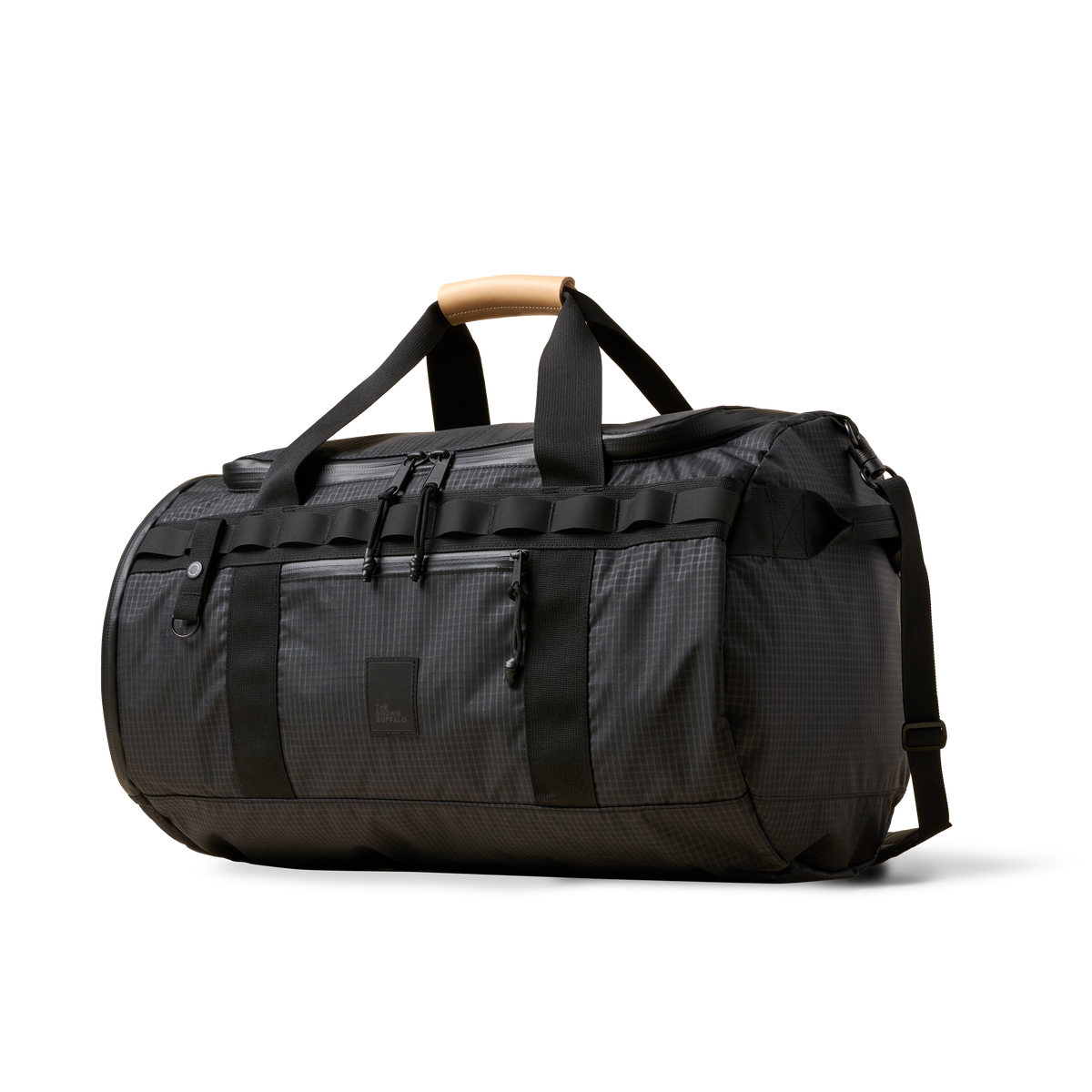 Duffalo duffel bag by The Brown Buffalo, charcoal fabric, black straps, tan leather handle on Tampa Home & Garden Store