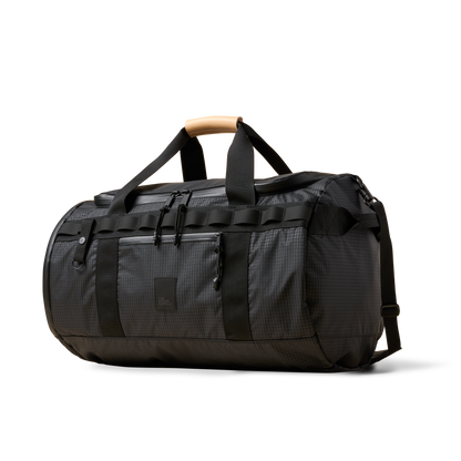 Duffalo duffel bag by The Brown Buffalo, charcoal fabric, black straps, tan leather handle on Tampa Home & Garden Store