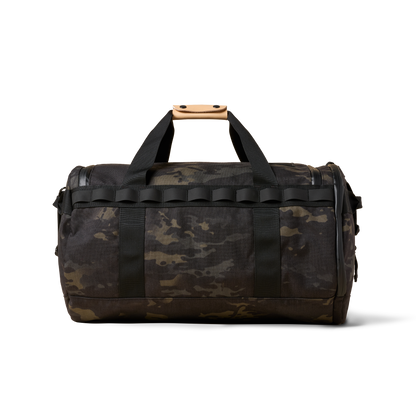 Duffalo camouflage duffel bag with tan leather top handle and black straps on Tampa Home & Garden Store