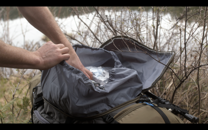 River Country Gear 75+ L backpacking pack opened; gray nylon exterior in brushy outdoors on Tampa Home & Garden Store