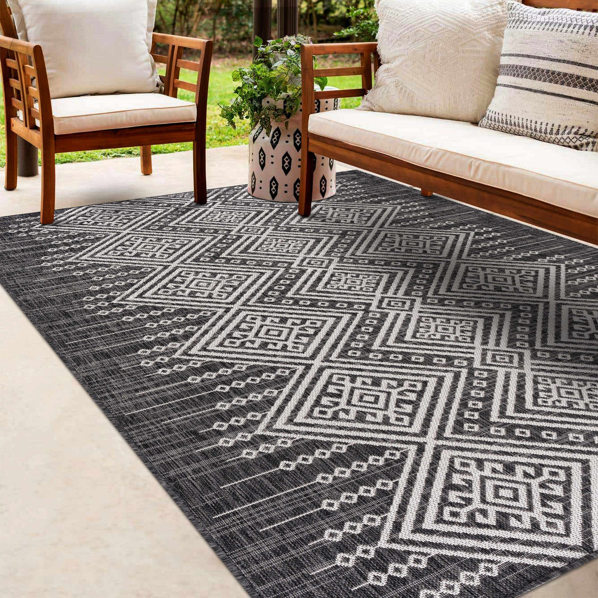 Frankville Black&White All-Over Outdoor Rug with geometric pattern by Boutique Rugs on a patio on Tampa Home & Garden Store