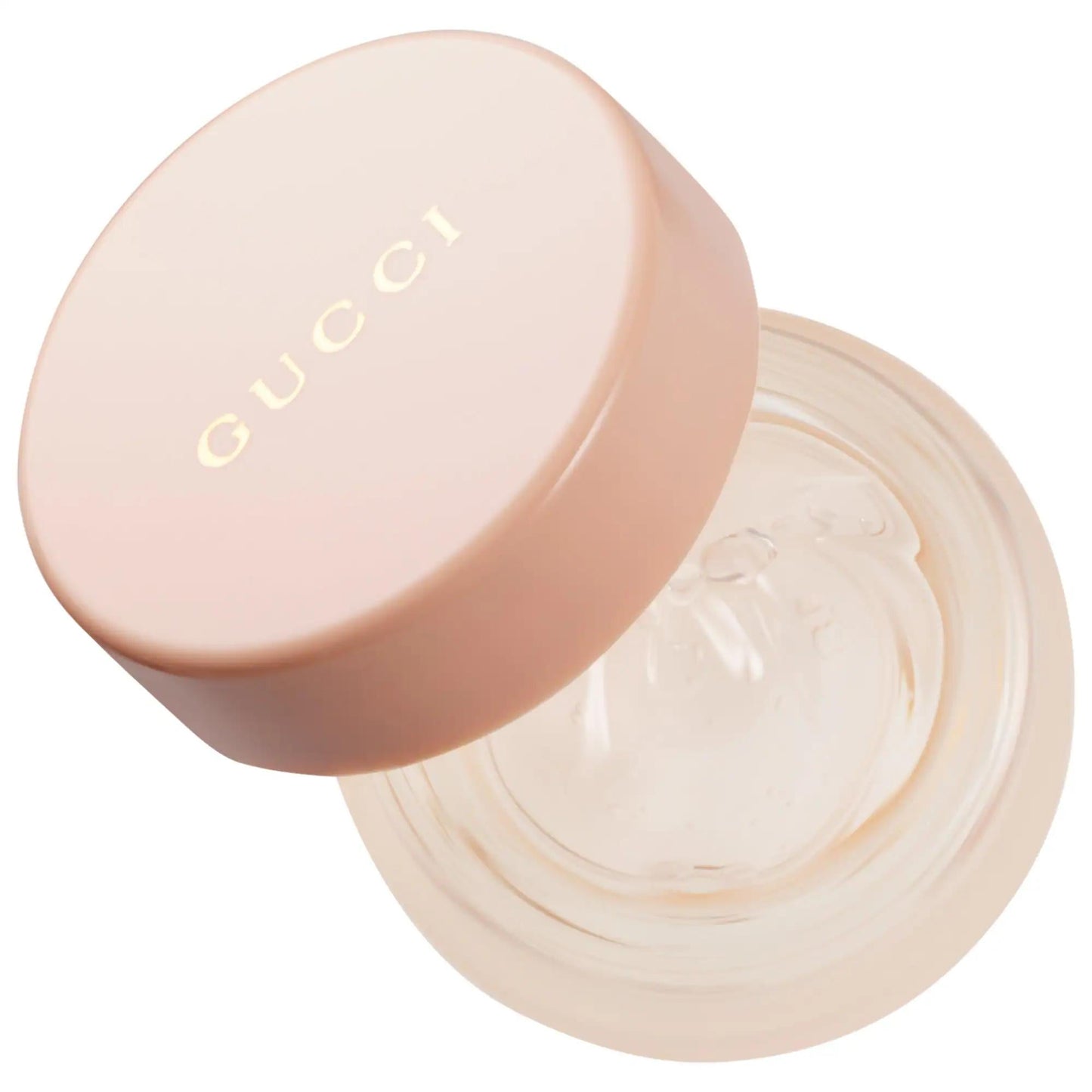 Lip gloss jar lid in soft pink with gold GUCCI logo, close-up on Tampa Home & Garden Store