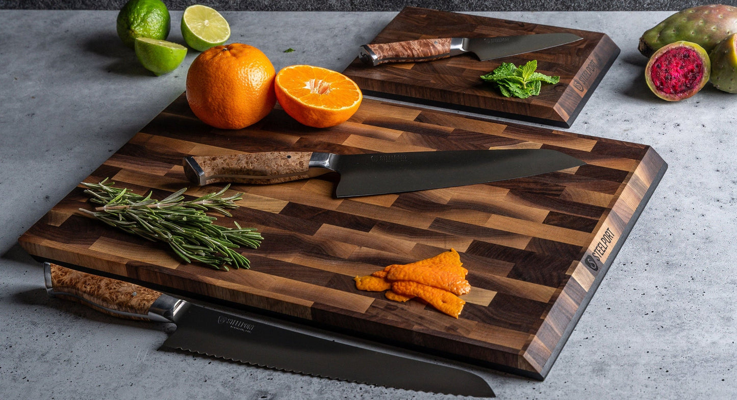 Signature Knife & Board Set by STEELPORT; burlwood-handled knives on boards with herbs on Tampa Home & Garden Store