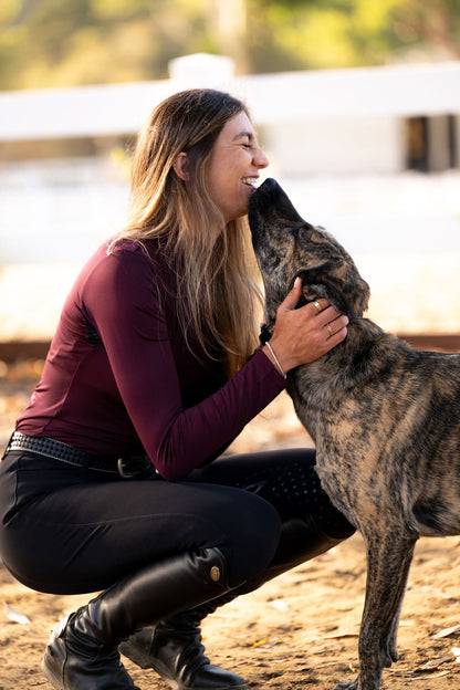 POPI Equestrian Top maroon long-sleeve riding top worn by a woman with a brindle dog on Tampa Home & Garden Store