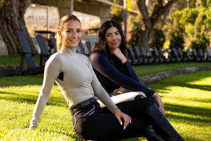 POPPI Equestrian Top BellEq long-sleeve sun top in beige and navy worn by two riders on grass on Tampa Home & Garden Store